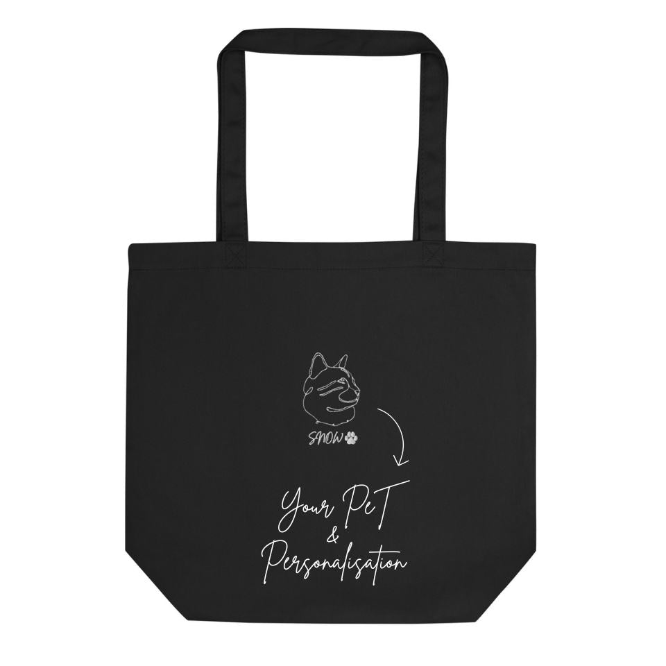 Black tote bag with white text and dog illustration on a white background