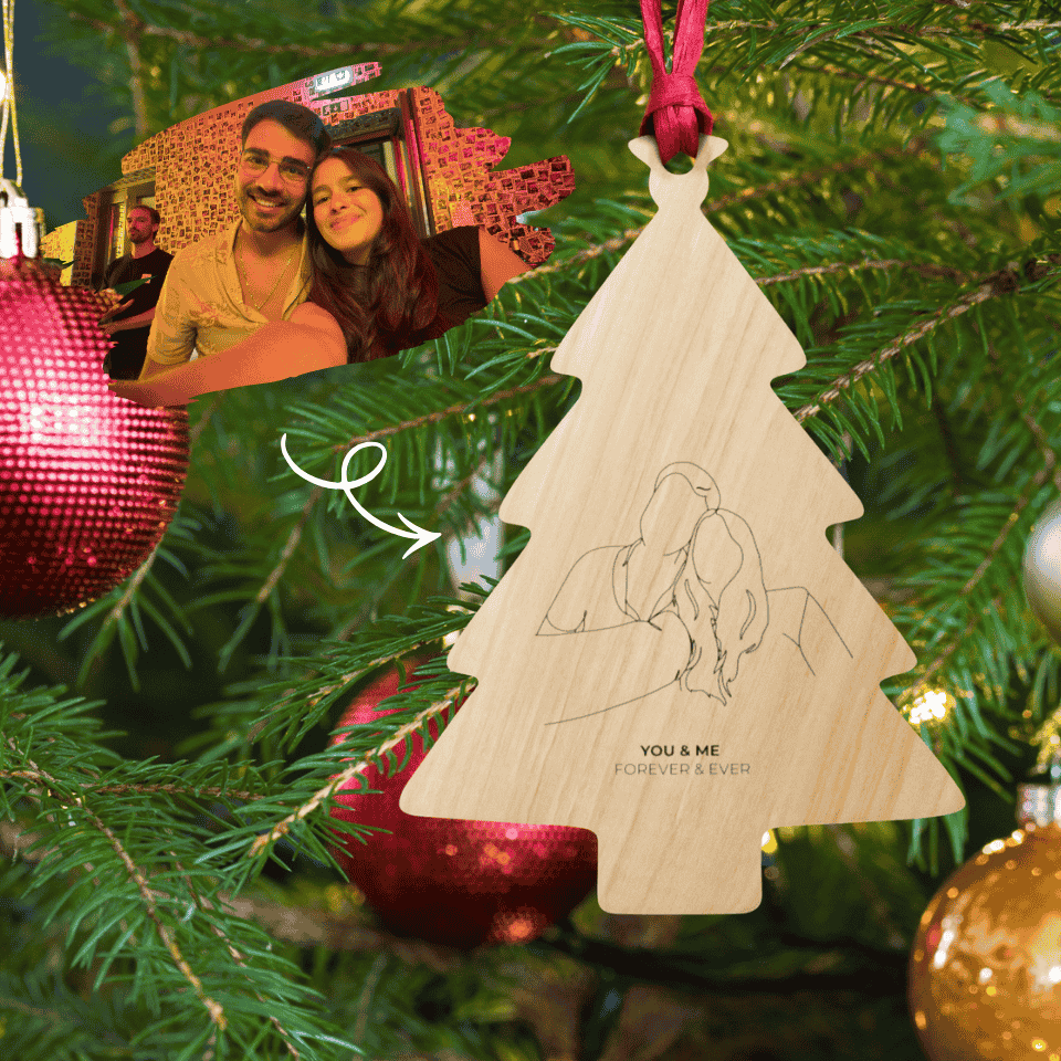 Decorative Christmas tree ornament with a couple's outline and 'You & Me Forever & Ever' text, hanging on a Christmas tree.